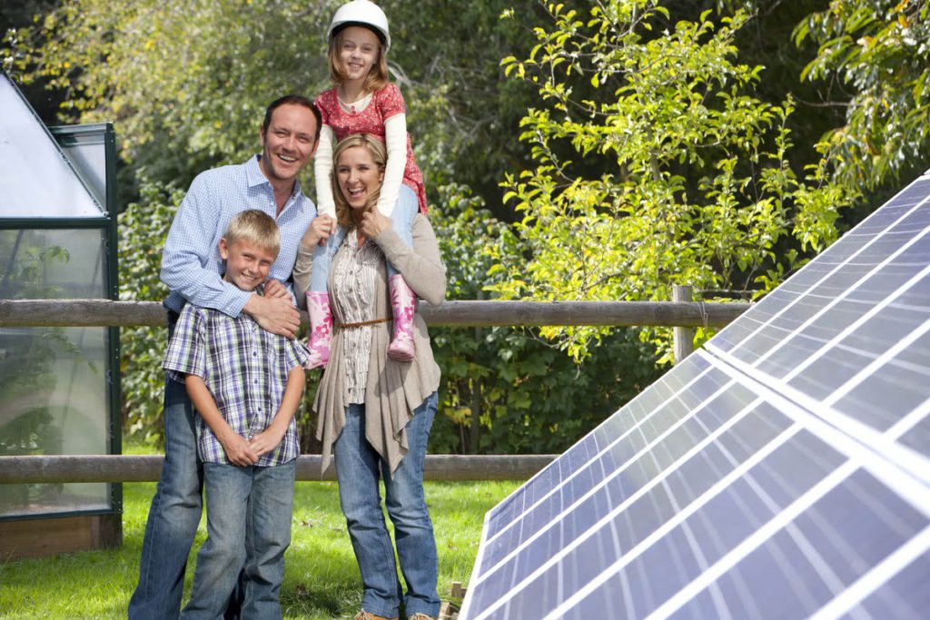Picture related to solar panel performance https://nevadasolargroup.com/wp-content/uploads/2021/10/Family-Standing-With-Solar-Module-1024x683.jpg